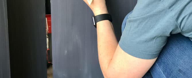 Woman applying paint with paintbrush